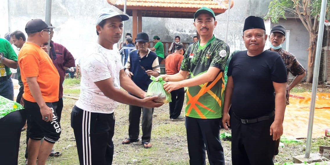 Ketua DPC PPP Gresik membagikan daging hewan kurban.